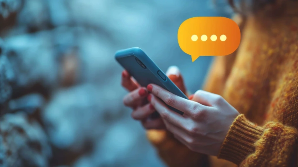 Hands holding a phone while receiving a message notification
